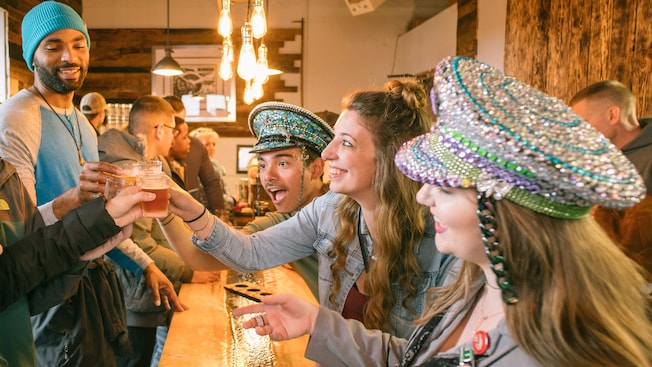 A group of joyful Guests raising their glasses together A group of joyful Guests raising their glasses together