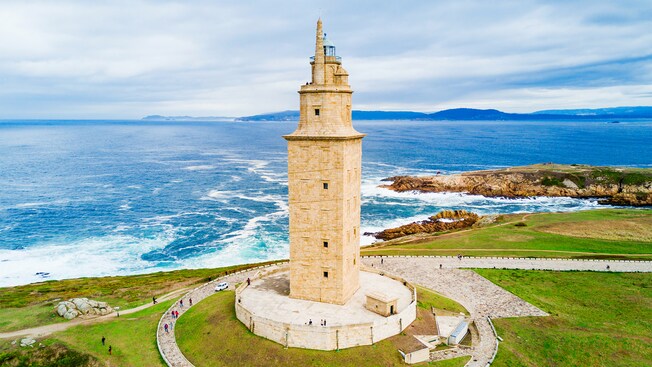 The stone Tower of Hercules standing next to the coastline