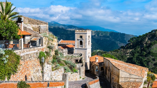 A historical Italian hamlet with stone paths, tile roofs and cast iron street lamps overlooking a valley A historical Italian hamlet with stone paths, tile roofs and cast iron street lamps overlooking a valley