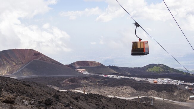 A cable car ascends Mount Etna in Sicily, Italy