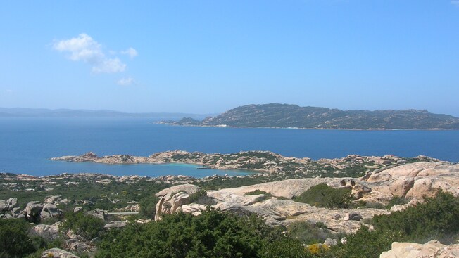 A rocky coastline that looks out to small islands
