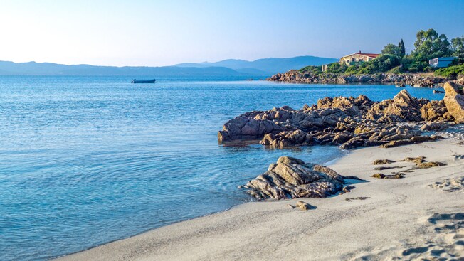 A sandy coastline with large stones