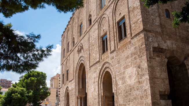 An outdoor arched corridor framed by large concrete bricks and a rope stretched between two metal poles An outdoor arched corridor framed by large concrete bricks and a rope stretched between two metal poles
