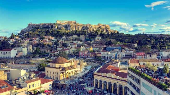 The city of Athens surrounding the hilltop Acropolis The city of Athens surrounding the hilltop Acropolis