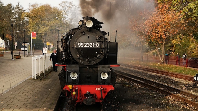 Smoke billowing out of a steam engine on the tracks Smoke billowing out of a steam engine on the tracks