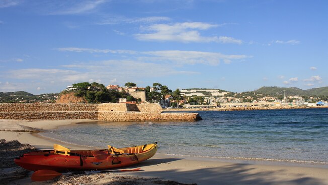 A kayak beached on the sands of a seaside resort town