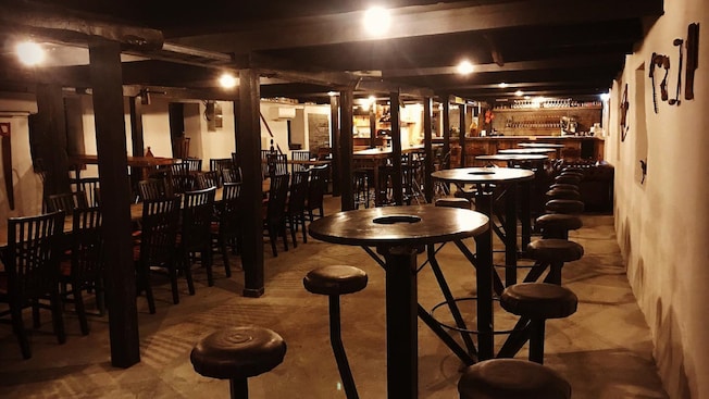 The interior of a pub reveals wooden tables and stools The interior of a pub reveals wooden tables and stools