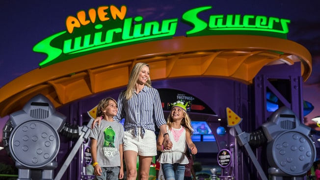 A woman and 2 kids stand in front of Alien Swirling Saucers