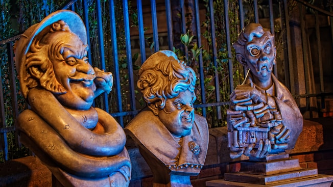 Statues of Bertie, Aunt Florence and Uncle Jacob in the Haunted Mansion queuing zone at Magic Kingdom park