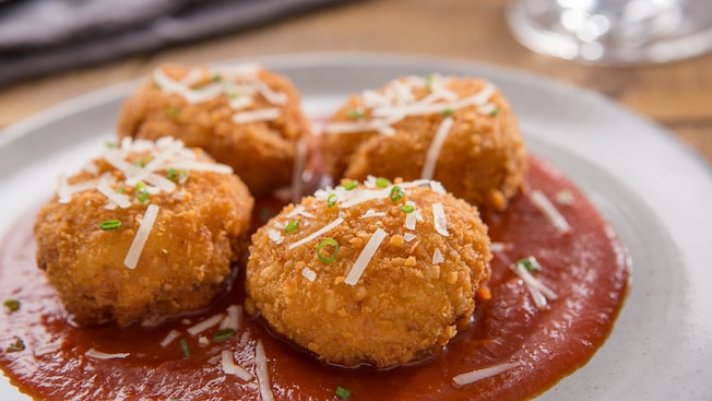 Fried macaroni and cheese on a tomato based sauce