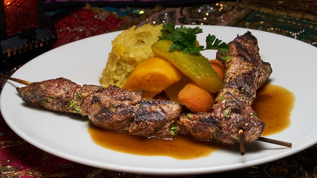 2 beef shish kebabs served with yellow rice and mixed vegetables
