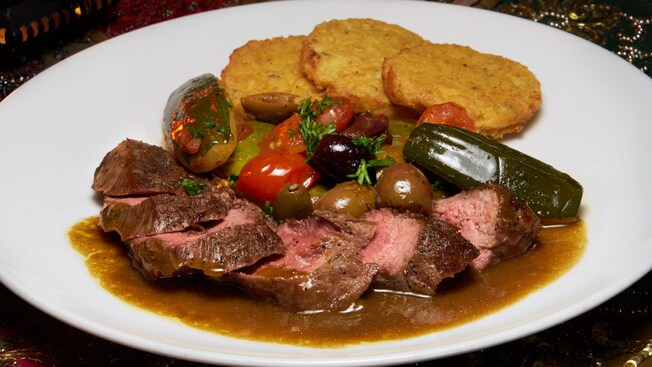 Juicy slices of lamb loin served with olives, zucchini and 3 small, crisp pancakes