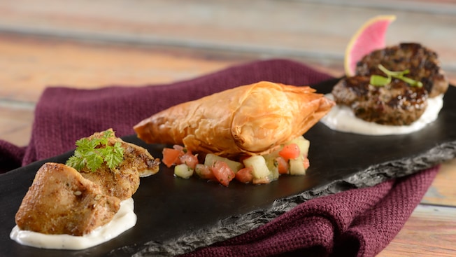 A sampler platter featuring 3 different foods at Spice Road Table