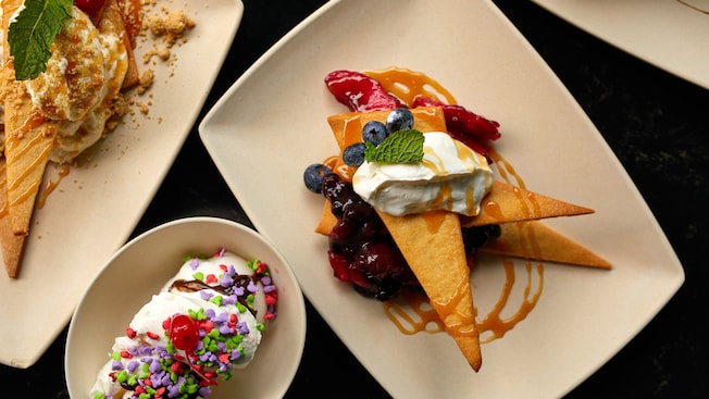 Three plates of desserts with caramel topping and blueberries