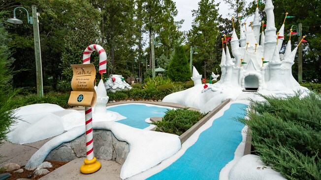 A miniature golf course hole featuring Cinderella Castle made of faux snow at Disneys Winter Summerland Miniature Golf Course