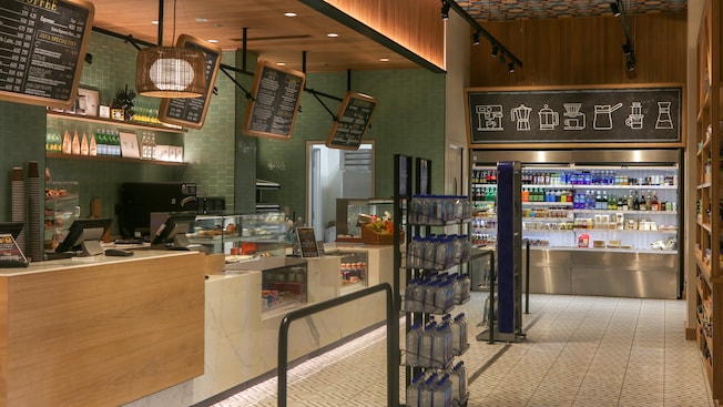 A contemporary cafe featuring a counter service ordering area and a refrigerator display case with take away beverages and snacks