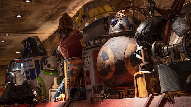 An old workshop shelf filled with spare parts from astromech droids, including both the B B 8 and R series 