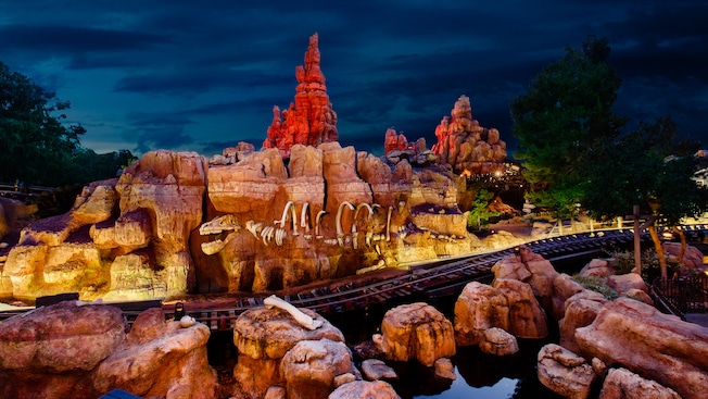 A section of Big Thunder Mountain Railroad with dinosaur bones embedded in rocky hills