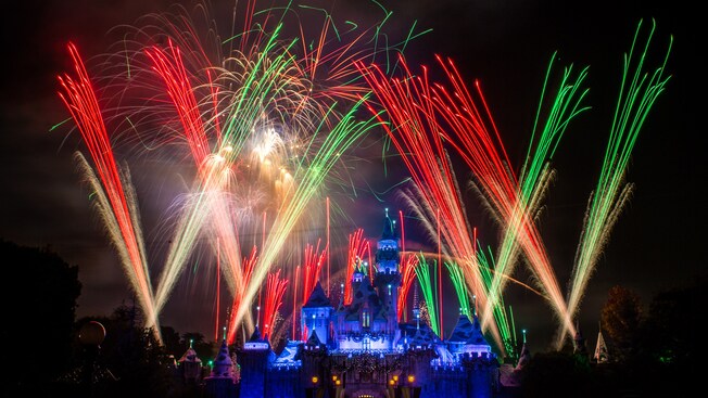 Festive fireworks and lasers lighting up the sky above Sleeping Beauty Castle.