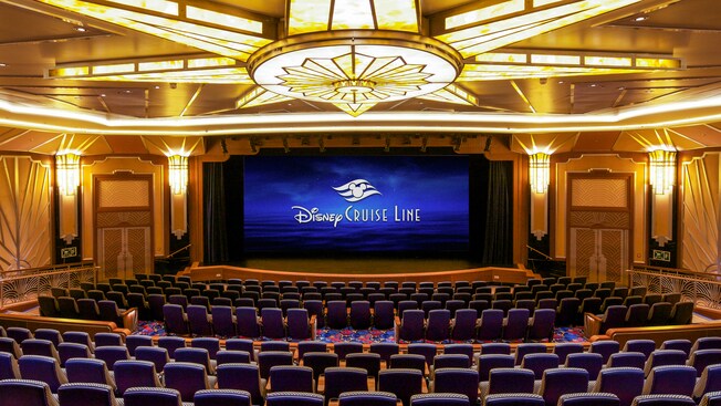 A spacious theater with a large stage and a high curtain