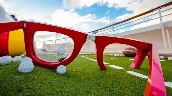 A giant pair of broken glasses acts as one of the obstacles on the outdoor putting green
