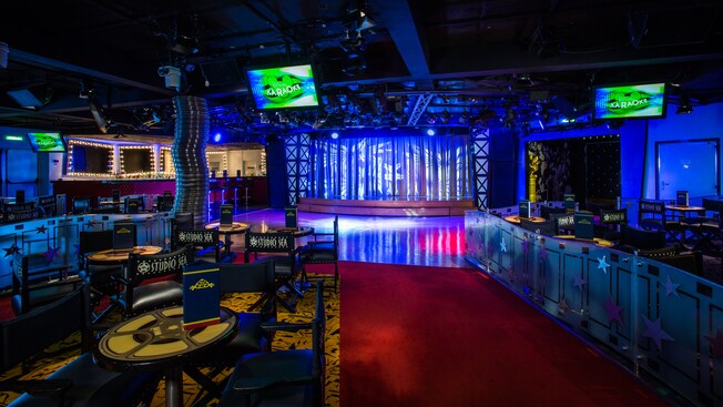 Parents and children participate in a live game show, Walk the Plank, in a kids lounge