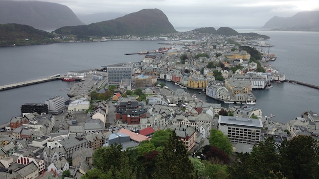 Two hilly islands covered with buildings sit in a bay under an overcast sky Two hilly islands covered with buildings sit in a bay under an overcast sky