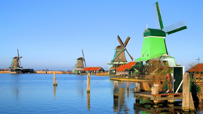 A village of windmills situated along the water in Zaanse Schans, Netherlands