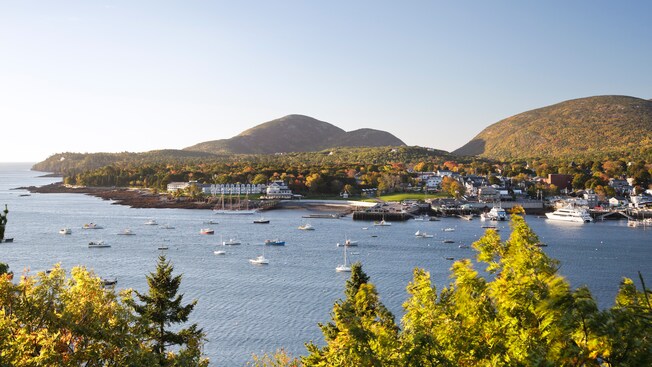 Hills bordering a body of water featuring boats