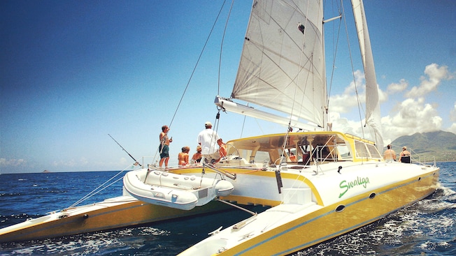 Guests relax on a catamaran Guests relax on a catamaran