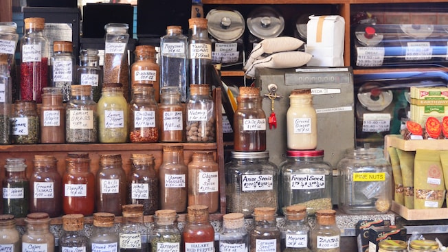 A spice shop displays an assortment of dried spices in glass containers A spice shop displays an assortment of dried spices in glass containers