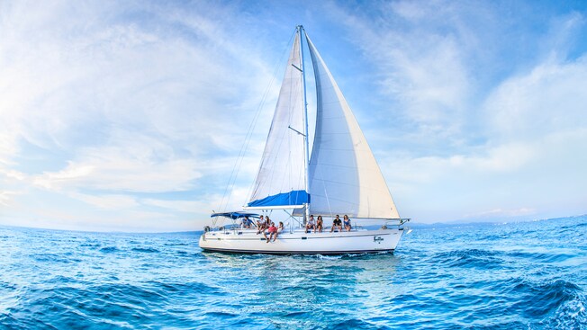 A sailboat in the ocean with 4 couples aboard