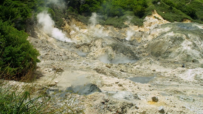 Sulfur escapes from vents in a rocky hillside Sulfur escapes from vents in a rocky hillside