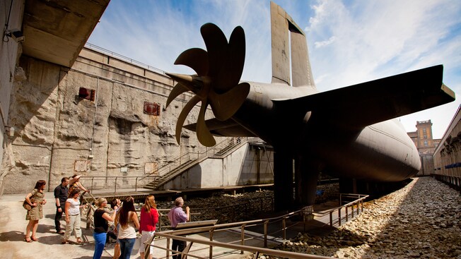 A group of people look at a submarine