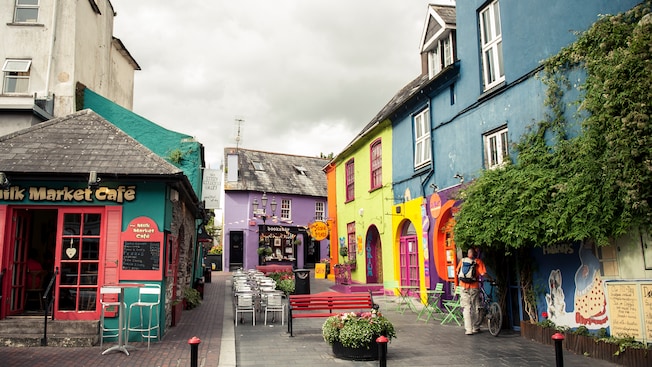 Quaint shops line a patio with tables, chairs and benches Quaint shops line a patio with tables, chairs and benches