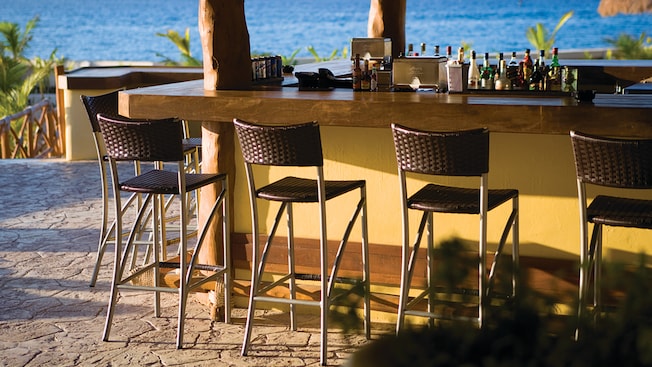 An outdoor bar provides views to the ocean An outdoor bar provides views to the ocean