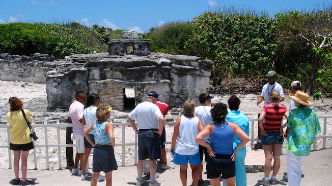 A tour group visiting ancient Mayan ruins