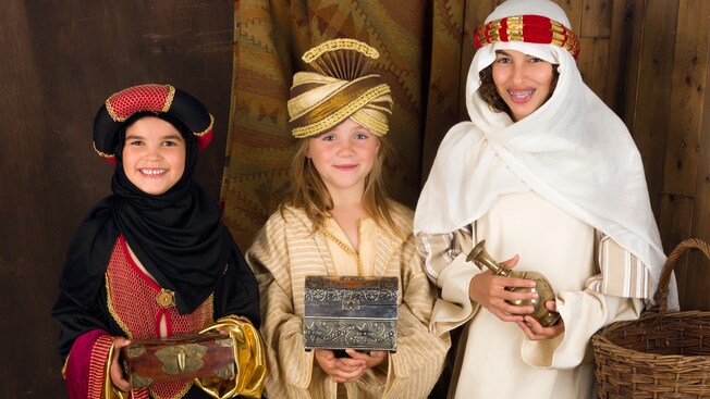 Children dressed as 3 wise men bearing gifts