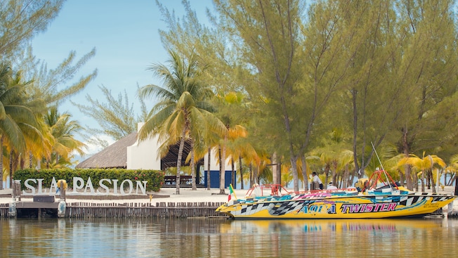 The Aqua Twister, a speedboat, docked next to a sign that says Isla Pasion The Aqua Twister, a speedboat, docked next to a sign that says Isla Pasion