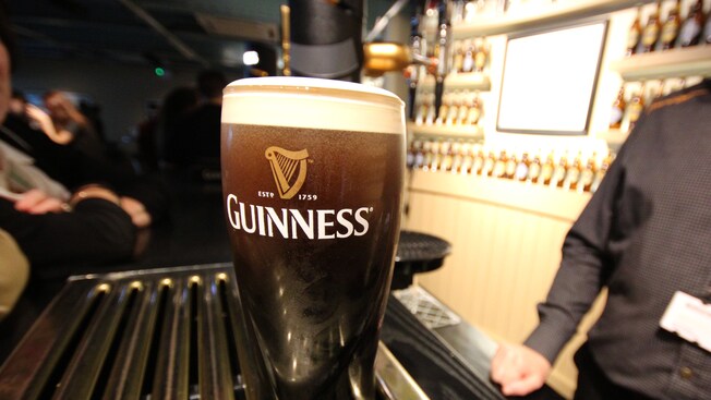 A tall pint of dark beer in a Guinness glass