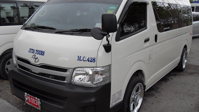 Front and side view of late model van with tinted windows