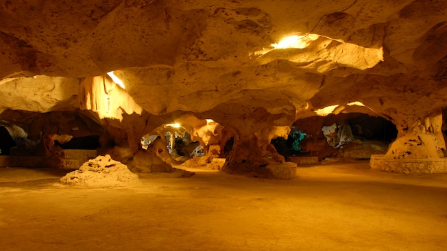 Sunlight peeks through ceiling openings in an underground cavern at Jamaicas Green Grotto Caves Sunlight peeks through ceiling openings in an underground cavern at Jamaicas Green Grotto Caves
