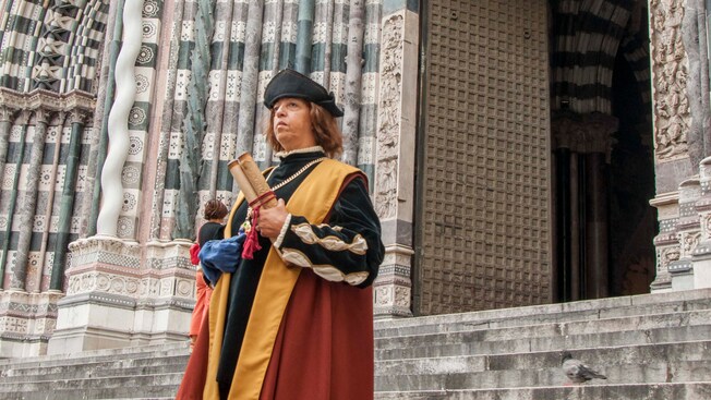 A Christopher Columbus impersonator stands on the steps of St. Lawrence Cathedral