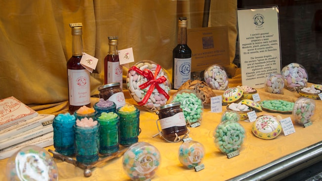 A table topped with containers of candy and syrup A table topped with containers of candy and syrup