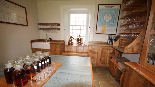 10 whisky jars set up next to 5 glasses for a tasting 10 whisky jars set up next to 5 glasses for a tasting