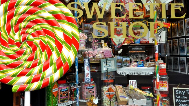 A store window featuring candy displays and greeting cards