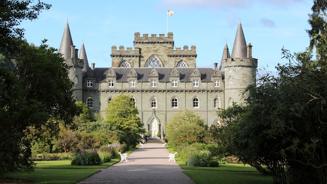 A path with benches flanked by manicured lawns leading to Inveraray Castle A path with benches flanked by manicured lawns leading to Inveraray Castle