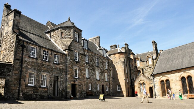 People walking along a cobblestone street outside of Stirling Castle