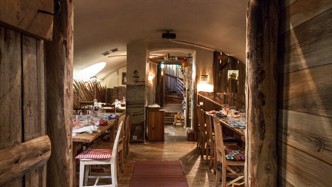 A restaurant seating area with chairs and set tables