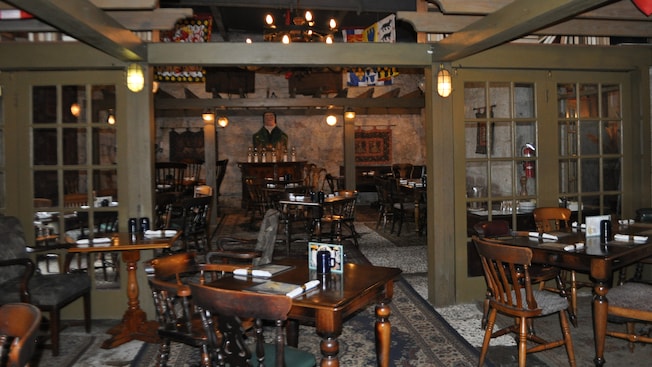A pub dining room furnished with antique wooden tables and chairs A pub dining room furnished with antique wooden tables and chairs
